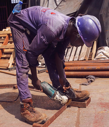 Goldfire signage engineer working with industrial tools