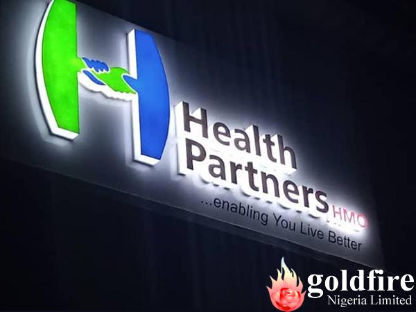 Night photos of Health Partners HMO - Ribadu, Road, Ikoyi signage produced and installed by Goldfire Nigeria Limited.
